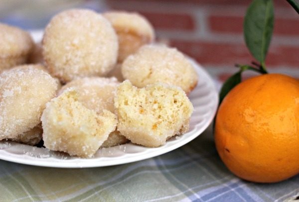 Lemon Poppers made with homemade lemon curd, and taste like a super moist donut hole dipped in lemon and sugar. Amazing dessert recipe!