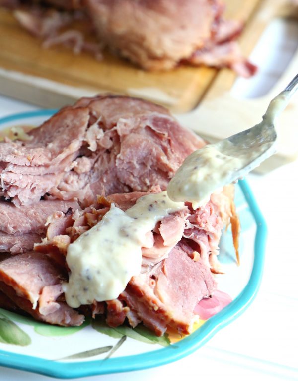 The Best Holiday Ham recipe, cooked in the slow cooker and served with a Yummy Sauce