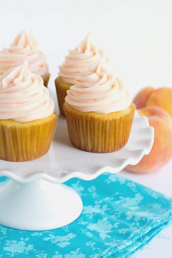 Yellow Cupcakes with Peach Cream Frosting from Cookie Dough and Oven Mitt